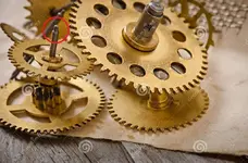 mechanical-clock-gears-old-wooden-table-43645003.webp