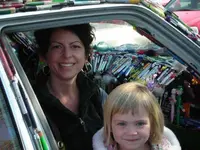 Mom and Daughter in the Pen Car.webp