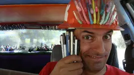 The Pen Guy and a bunch of donated pens.webp
