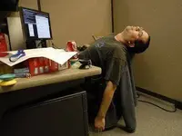 sleeping-work-cubicle-stressed-office.webp