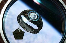 Cosmonavigator floating in front of a porthole with the Earth in the background-L.jpg